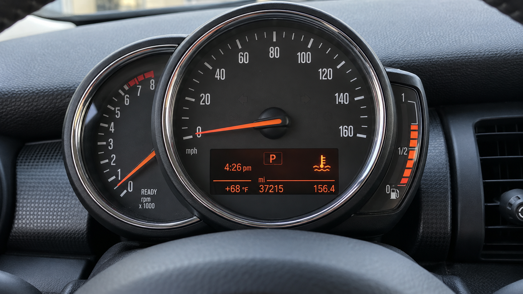 AI-generated illustration of a MINI-style analog instrument cluster with a coolant temperature warning.